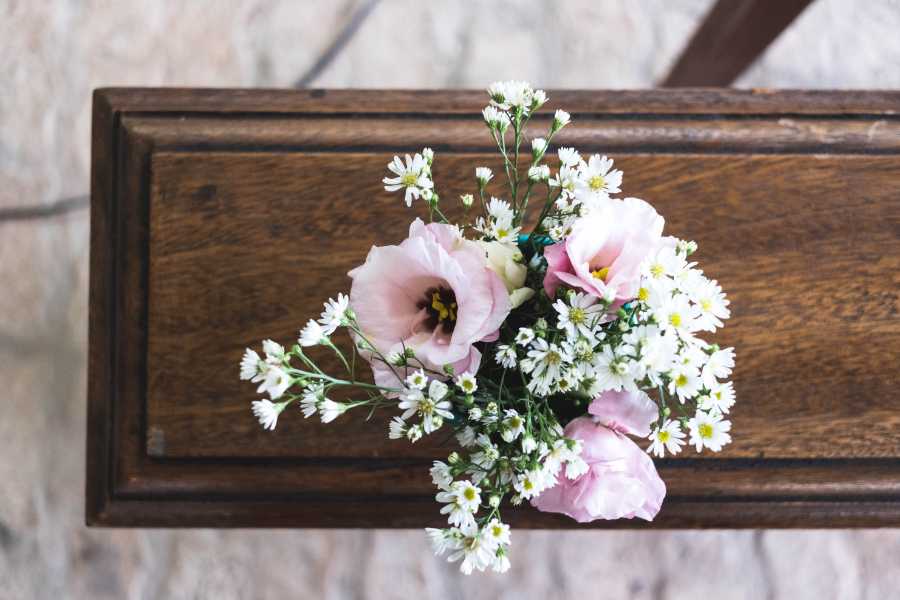 Begravningskista med vackra, rosa blommor på